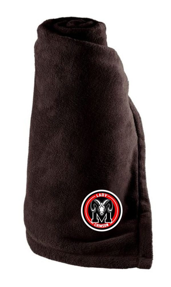 A rolled-up Manual Lady Crimson Soccer Tailgate Blanket with a "lady m crimson" logo patch on the lower section.