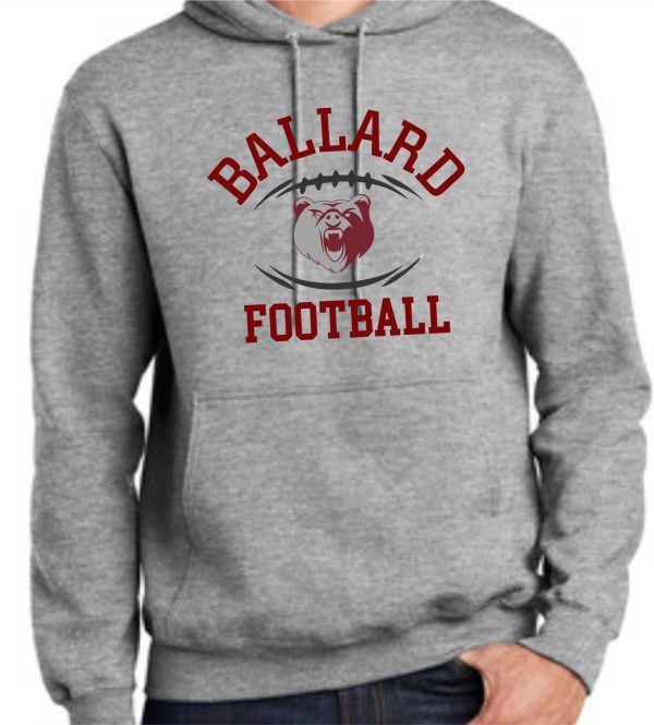 Ballard Football Hoodie PC90H featuring "ballard football" text and a bear mascot logo on the front, worn by a person visible from the neck down.