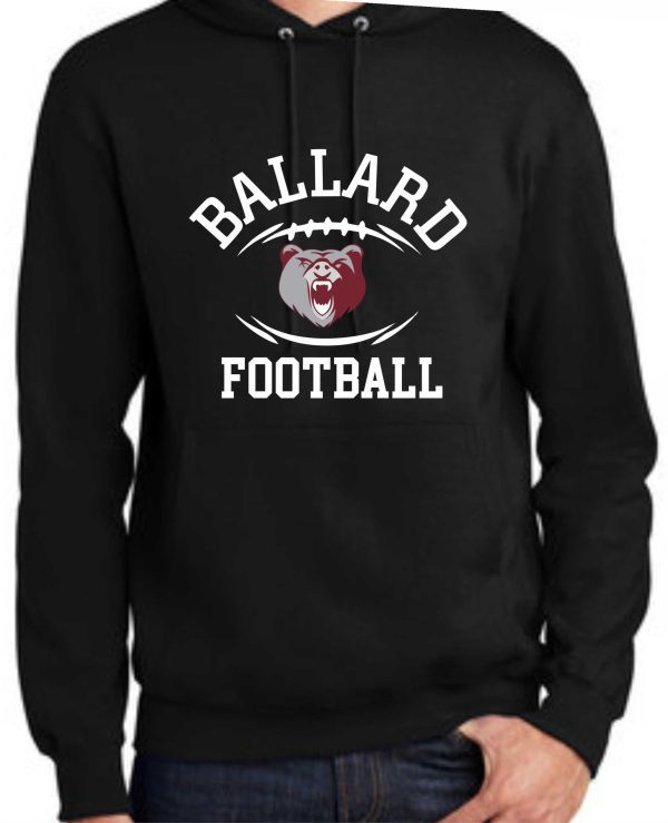 A person wearing a Ballard Football Hoodie PC90H with "ballard football" text and a bear mascot graphic on the front.