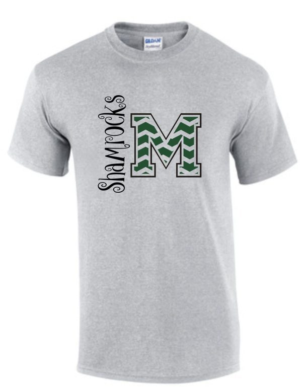 Gray St Martha Shamrock Chevron M Spirit T-shirt with a green and white "m" logo and the word "shamrocks" in a curved black script above it.