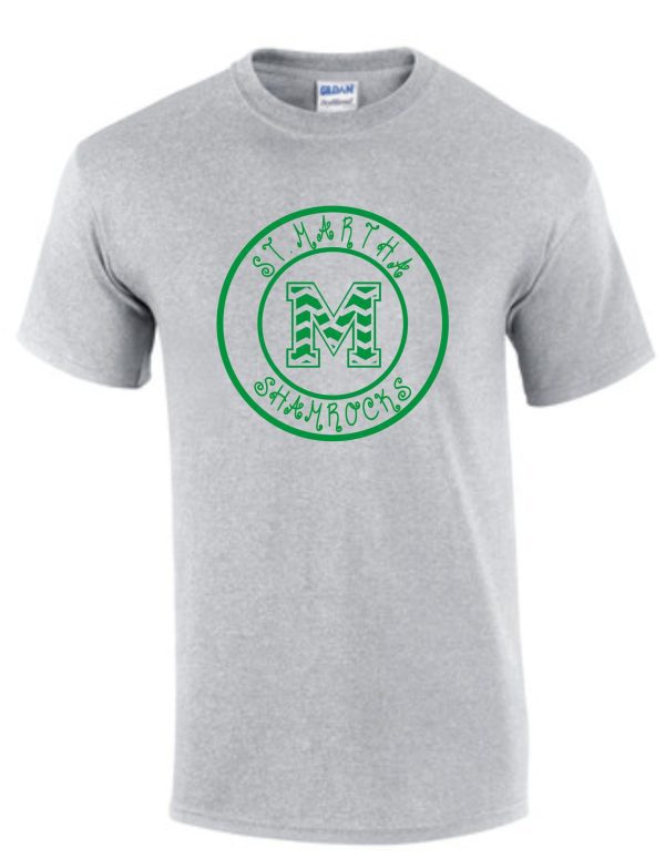 Gray t-shirt with a green logo featuring the St Martha Shamrock Circled Chevron M Spirit T.