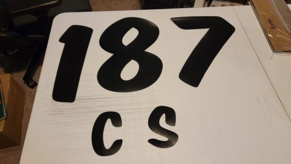 Black numbers 187 and letters CS.